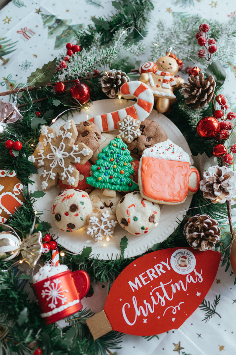 Decorative Christmas wreath with cookies, candy, and a 'Merry Christmas' sign. Bloom and Brew Coffee Company.